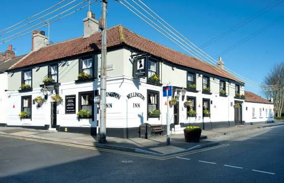 The whitewashed exterior of The Wellington Inn on Wolviston High Street